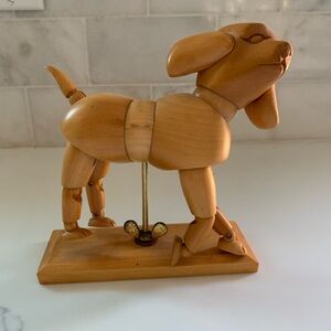 Articulated wooden dog mannequin, used as a reference tool for artists.